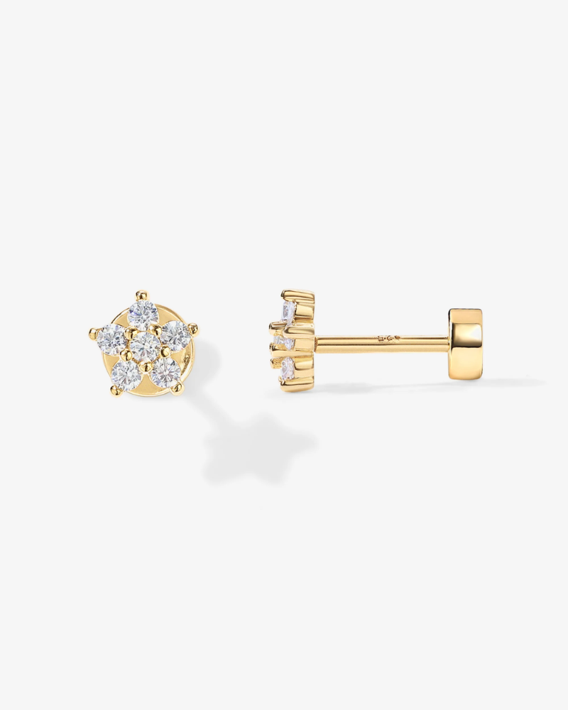 Gold earrings with diamond-like stones on a white background