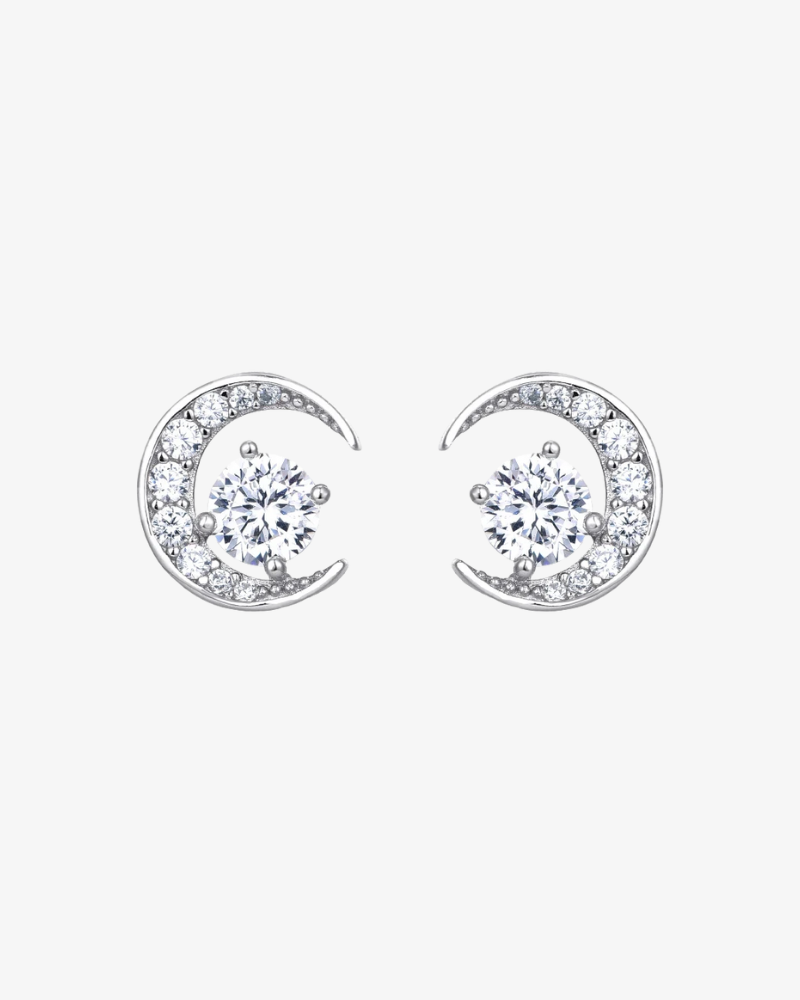 Pair of silver moon-shaped earrings with clear gemstones on a white background