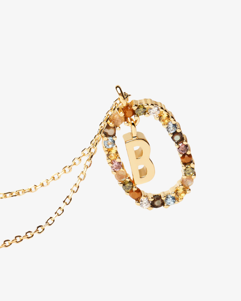 Gold necklace with a letter 'B' pendant on a white background