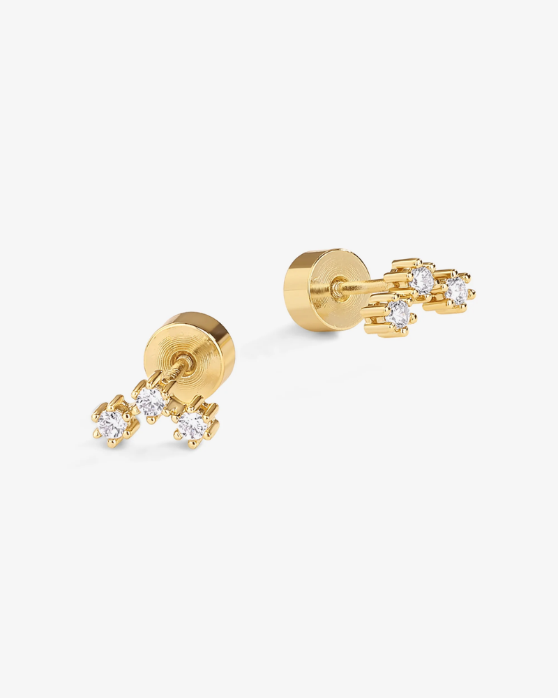 Gold earrings with small diamonds on a white background