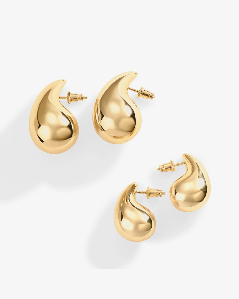 Gold earrings on a white background