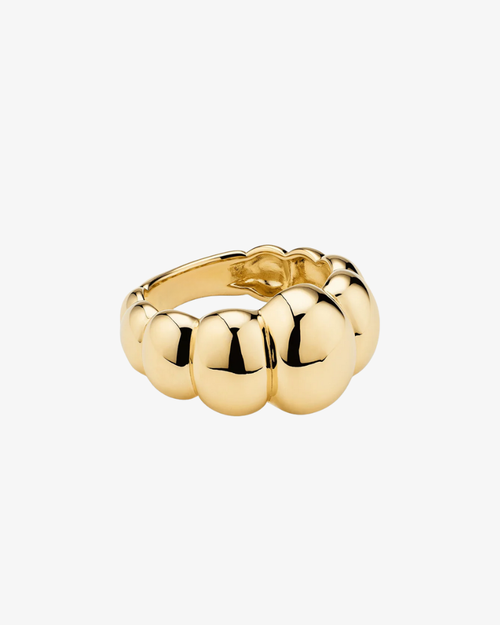 Gold ring with round beads on a white background