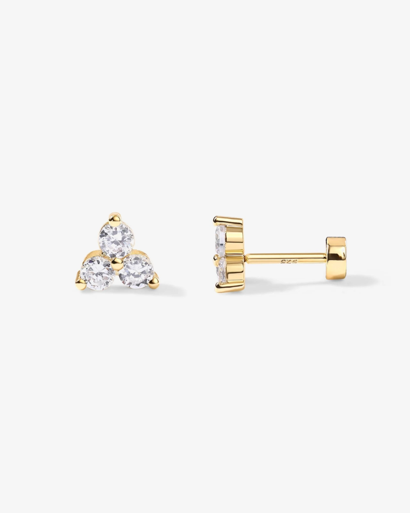 Gold earrings with clear gemstones on a white background