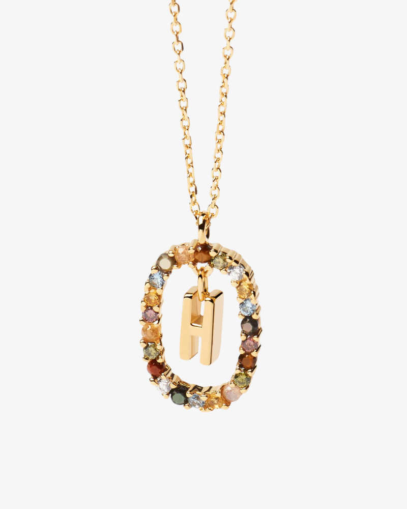 Gold necklace with multicolored gemstones and a letter 'H' pendant on a white background