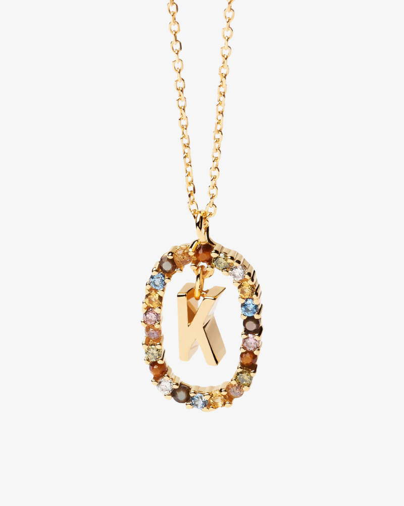 Gold necklace with a letter 'K' pendant on a white background
