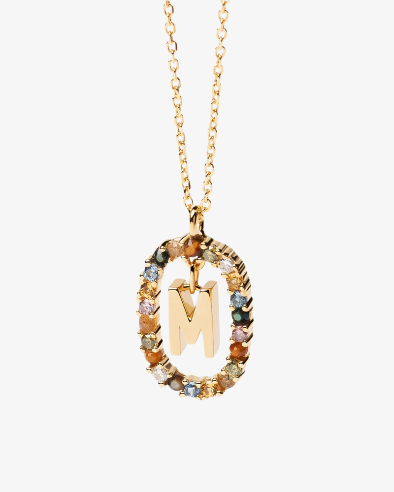 Gold necklace with a multicolored 'M' pendant on a white background