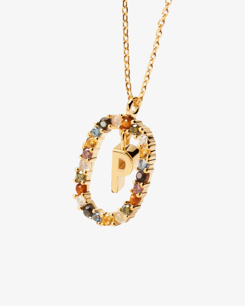 Gold necklace with a circular pendant featuring the letter 'P' on a white background
