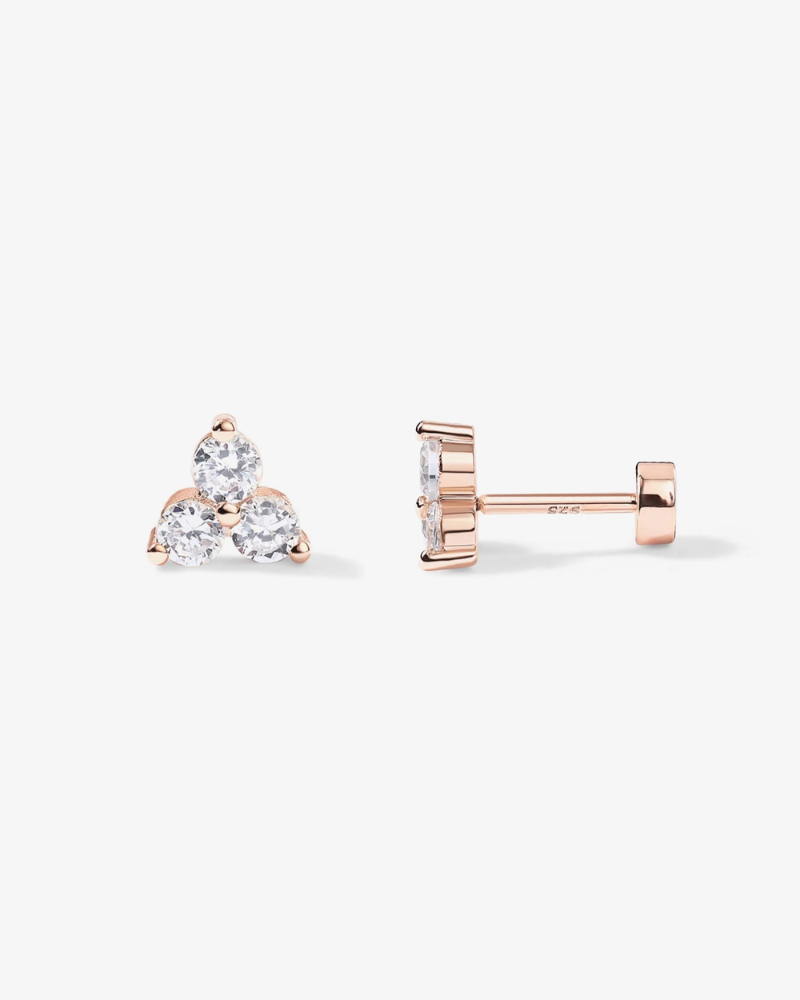 Rose gold earrings with clear gemstones on a white background