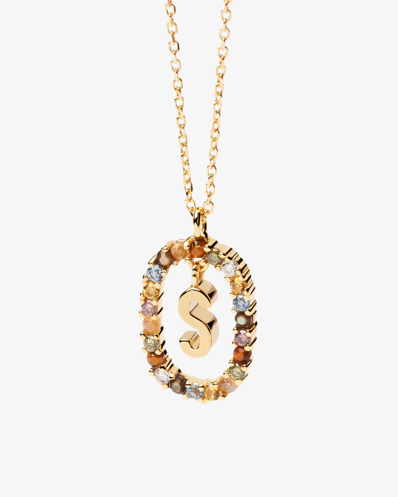Gold necklace with a multicolored 'S' pendant on a white background