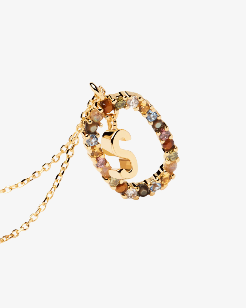 Gold necklace with a letter 'S' pendant on a white background