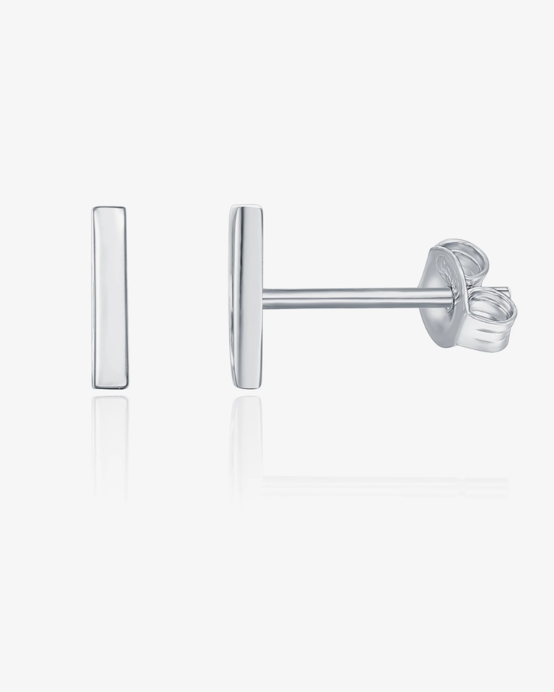 Silver earring on a light gray background