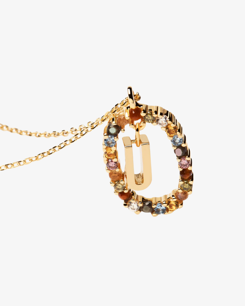 Gold necklace with multicolored gemstones on a white background