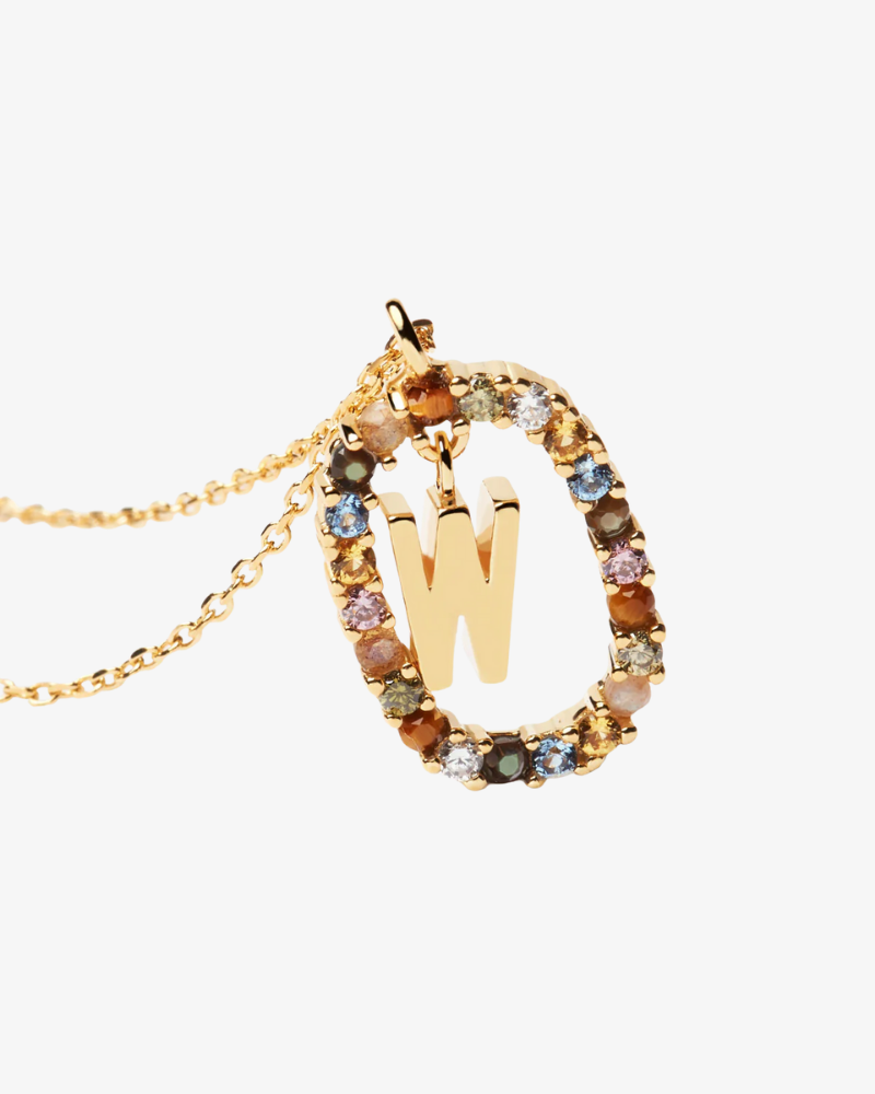 Gold necklace with a letter 'W' pendant featuring multicolored gemstones on a white background