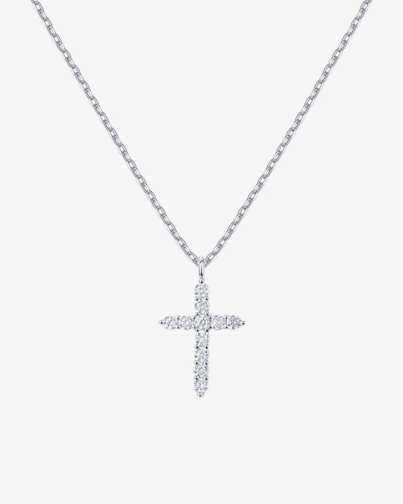 Diamond cross necklace on a light gray background