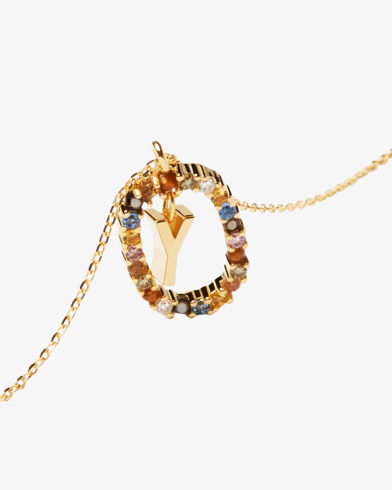 Gold necklace with a colorful pendant on a white background