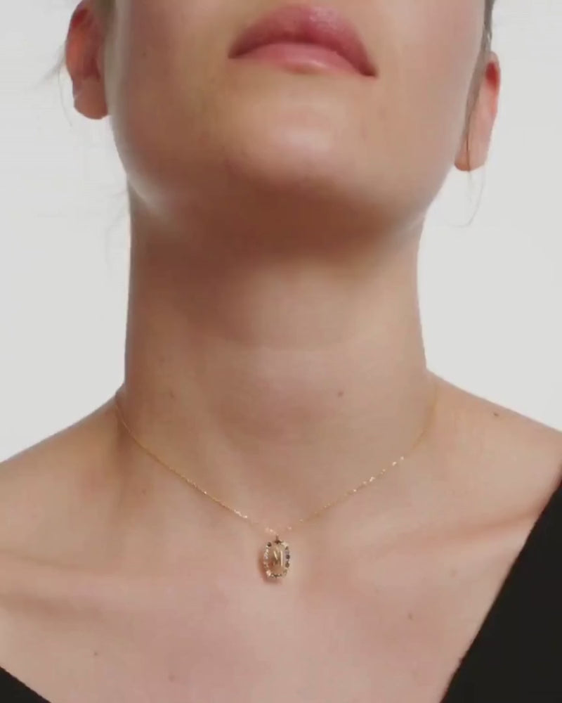 Video of model wearing Crystal Letter Necklace with initial 'M" pendant on gold chain